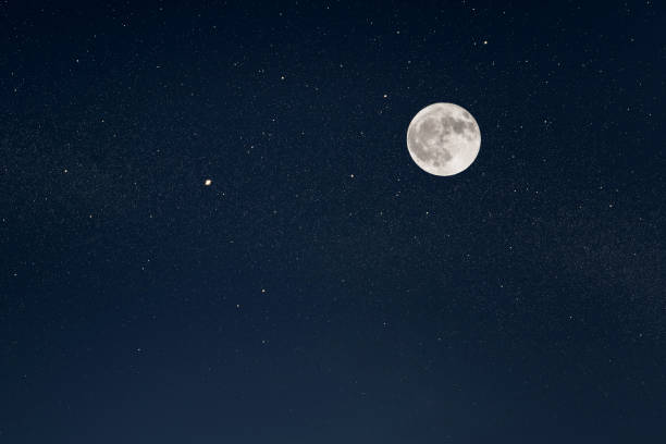 Huge full moon on the night sky with bright stars stock photo
