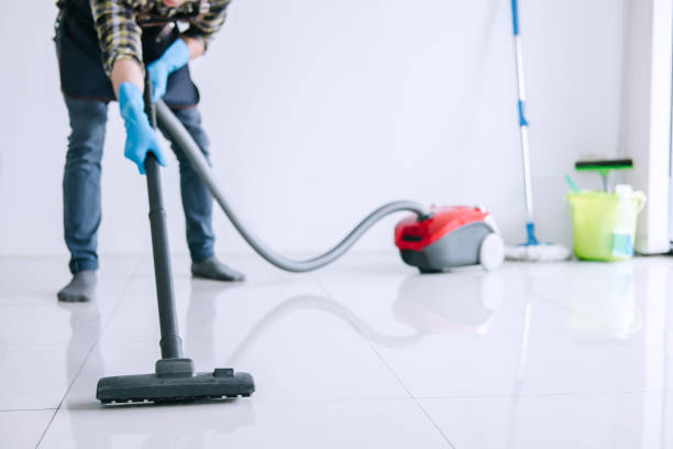 istock Housekeeping and housework cleaning concept, Happy young man in blue rubber gloves using a vacuum cleaner on floor at home 1090495344