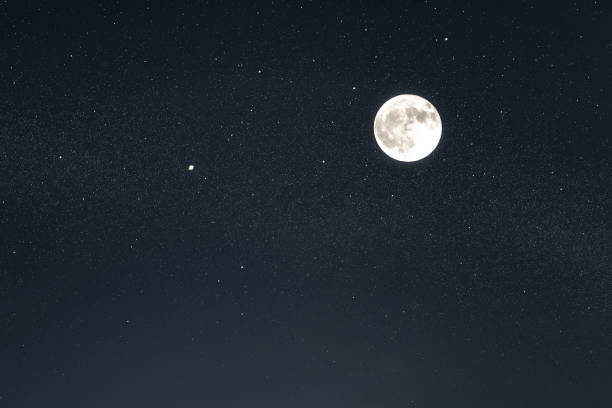 istock Huge full moon on the night sky with bright stars 1090495742