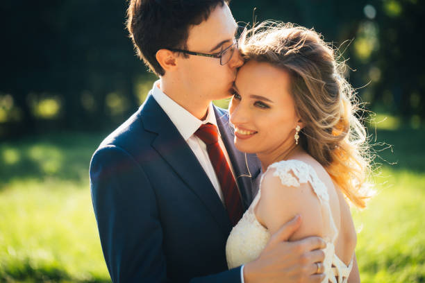 istock bride and groom embracing on nature background 1090499986