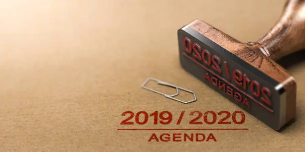 Rubber stamp and 2019 2020 agenda printed on kraft paper background. 3d illustration.