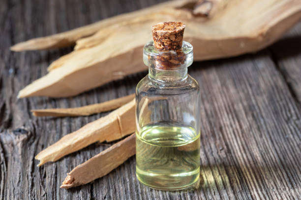 A bottle of sandalwood essential oil with white sandalwood stock photo