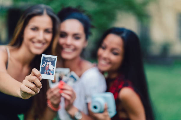 istock Friends taking instant photos outside 1090507946