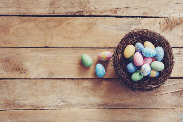 istock Colorful Easter egg and nest on wooden table background with copy space. 1090510824