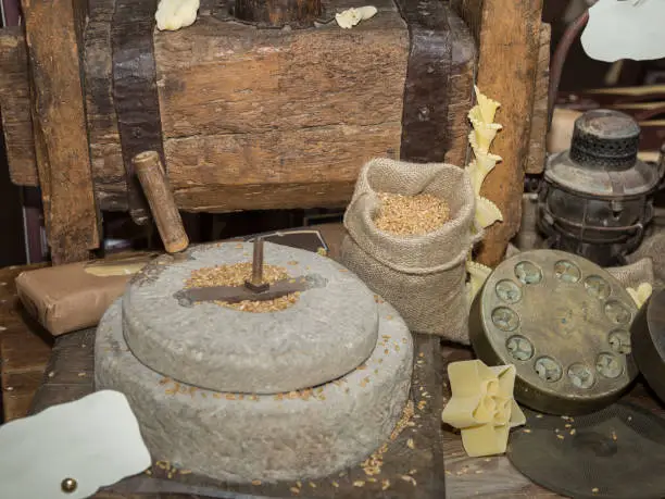 Photo of Ancient Stone Mill: Manual Grinder Wheel with Crank and Wooden Press for Pasta