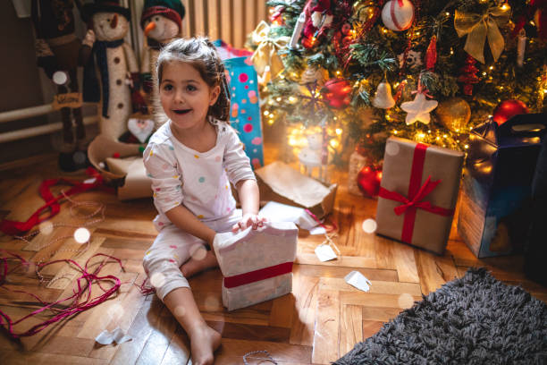 istock Gorgeous and excited child opening Christmas presents 1090514078