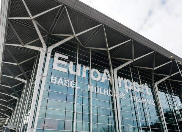 EuroAirport glass facade in Basel, Sqitzerland street view Basel: Basel Mulhouse Freiburg EuroAirport glass facade - wide angle view with big text printed on the glass mulhouse photos stock pictures, royalty-free photos & images