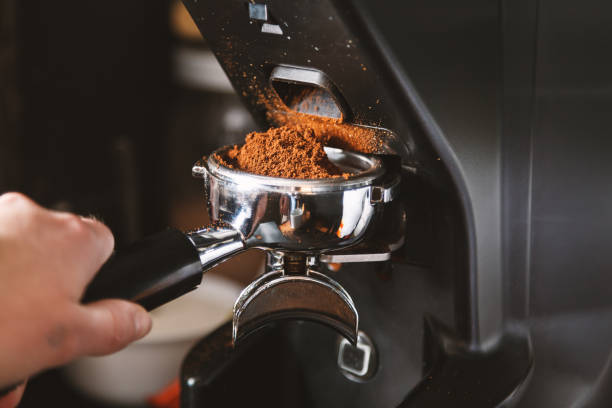 istock Barista grinding coffee beans using coffee machine, coffee grinder grinding freshly roasted make beans into a powder. 1090518440