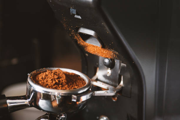 istock Barista grinding coffee beans using coffee machine, coffee grinder grinding freshly roasted make beans into a powder. 1090518466