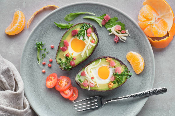 istock Keto diet dish: Avocado boats with ham cubes, quail eggs and cheese, top lay 1090520650