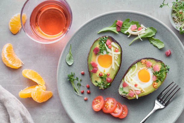 istock Keto diet dish: Avocado boats with ham cubes, quail eggs and cheese, top lay 1090520886