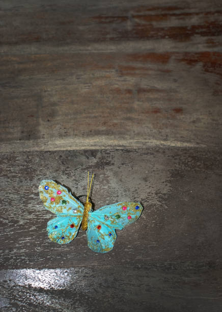 istock Dreamy turquoise beautiful butterfly on brown rustic wood 1090523492