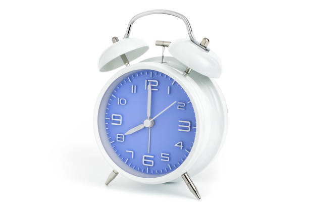 istock Twin bells analogue alarm clock with blue clock face shows eight o
