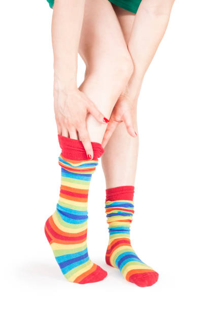 Perfect long female legs in rainbow pantyhoose Perfect long female legs in rainbow pantyhoose woman putting on socks stock pictures, royalty-free photos & images