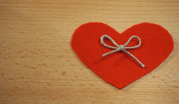 istock Heart background with free space for text. Heart made form textile decorated with linen rope bow 1090525512