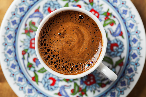 Black coffee in traditional Turkish cup, close up