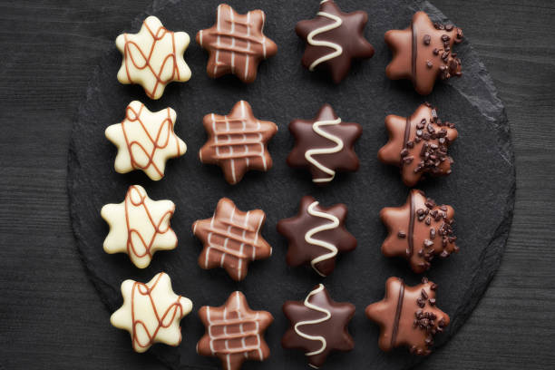 istock Star-shaped chocolates on dark wooden background 1090528862