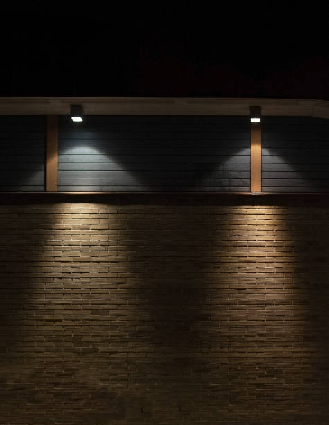 istock Brick and wood wall background in darkness with lights 1090532904
