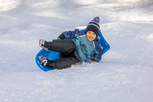 istock Young Boy Sledding Winter Wonderland 1090533058