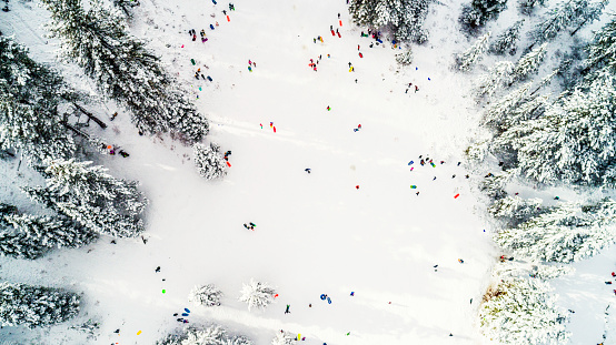Aerial drone photo, directly above sledding near Lake Tahoe on the Nevada side of the mountainous, pristine lake resort area during winter after a fresh snowstorm.