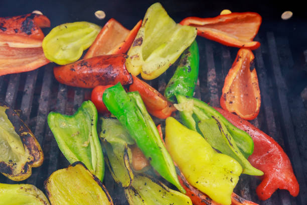 Roasted colorful bell pepper at on the grill, red and yellow peppers