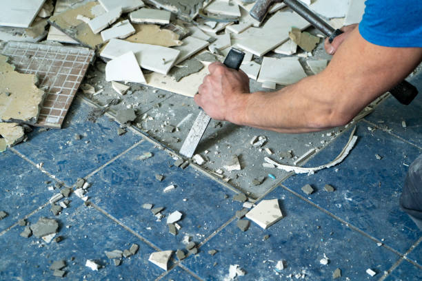 Worker remove, demolish old tiles in a bathroom with hammer and chisel Worker remove, demolish old tiles in a bathroom with hammer and chisel chisel photos stock pictures, royalty-free photos & images