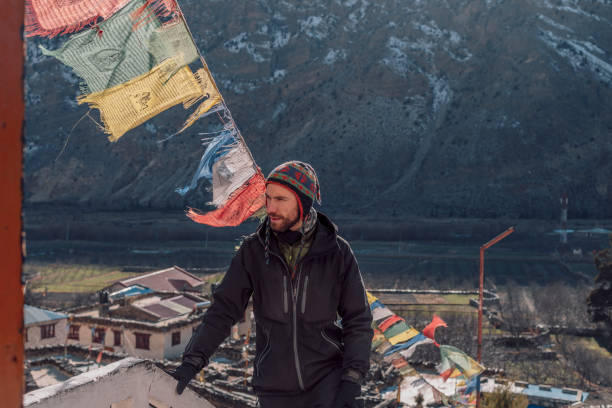 istock Young man in the mountains with flags, Nepal 1090546618
