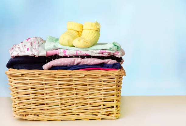 istock Basket with children's clothes on the table 1090549344