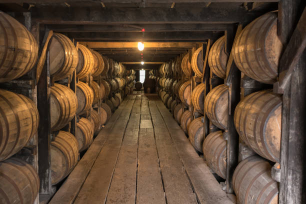 Looking Down Walkway in Bourbon Aging Warehouse Looking Down Walkway in Bourbon Aging Warehouse Basement bourbon whiskey stock pictures, royalty-free photos & images