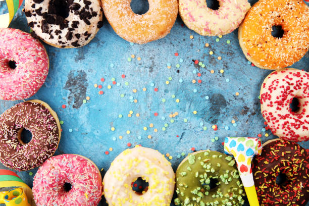 istock assorted donuts with chocolate frosted, pink glazed and sprinkles donuts 1090555248