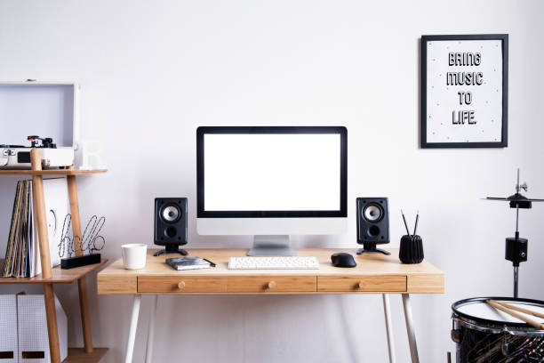 istock Scandinavian interior of home creative desk with mock up computer screen, photo frame, speakers, office accessories, drums and gramophone. Minimalistic space for work, hobby and listen music. 1090555274