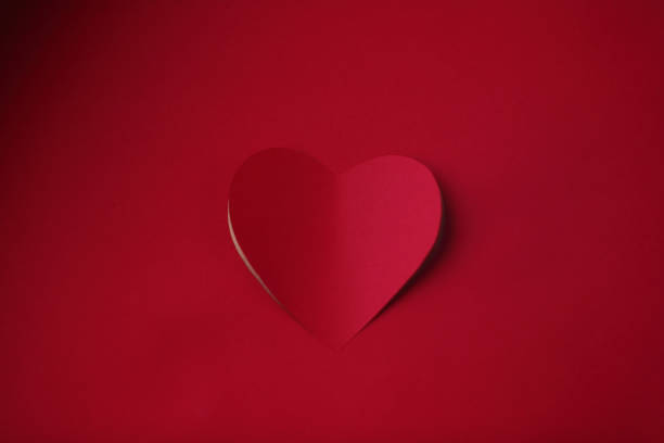 istock Heart cut in paper background 1090555590