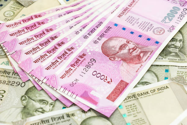 istock New 2000 indian rupees banknotes over 500 rupees banknotes background. 1090557138