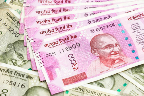 istock New 2000 indian rupees banknotes over 500 rupees banknotes background. 1090557154