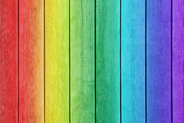 istock Vertical wooden planks painted as rainbow with ribbed surface as texture, background 1090557416