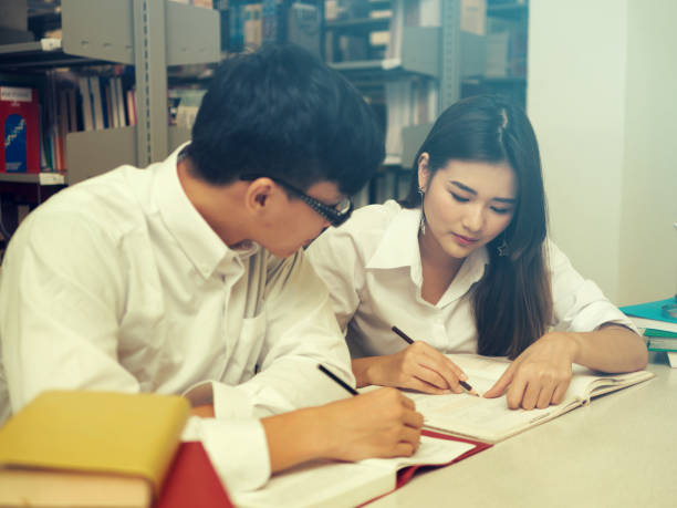 istock Young students campus helps friend catching up and learning tutoring. People, learning, education and school concept. 1090559976