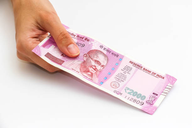istock Hands holding new 2000 indian rupees banknotes. 1090560092