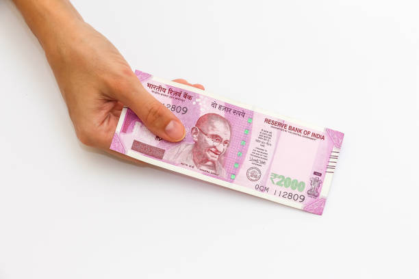 istock Hands holding new 2000 indian rupees banknotes. 1090560096