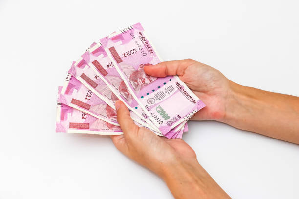 istock Hands holding new 2000 indian rupees banknotes. 1090560316
