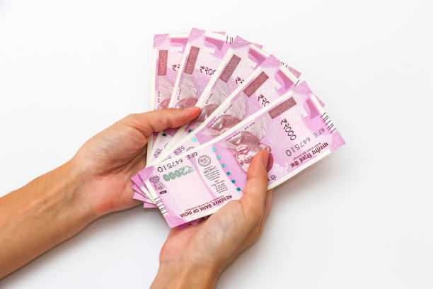 istock Hands holding new 2000 indian rupees banknotes. 1090560326