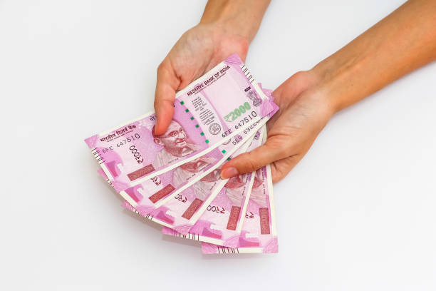 istock Hands holding new 2000 indian rupees banknotes. 1090560348