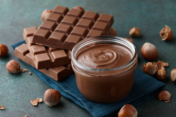 istock Chocolate spread with hazelnuts on blue green countertop 1090560818