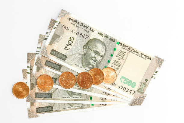 istock New indian 500 rupees banknotes and coins on white background. 1090561016