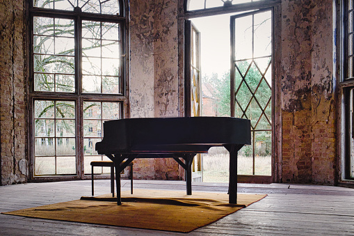 An old abandoned piano in the leftovers of the former sanatorium in Oranienburg, Germany