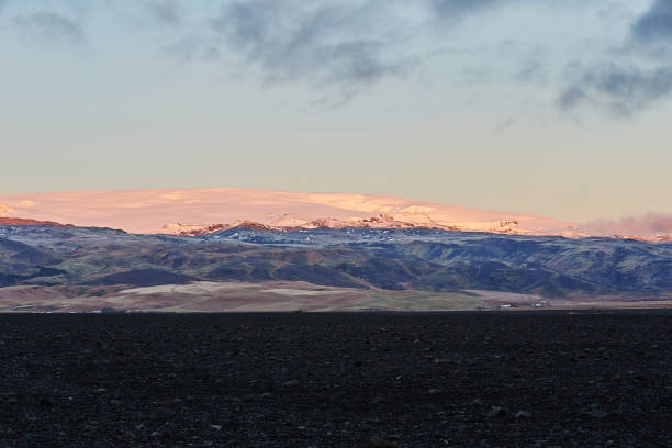 istock Icelandic Sunset over mountain black stones in foreground 1090565092