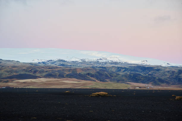 istock Icelandic Sunset over mountain black stones in foreground 1090565130