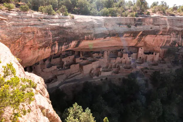 Mesa Verde National Park is in southwest Colorado. It's known for its well-preserved Ancestral Puebloan cliff dwellings, notably the huge Cliff Palace. The Chapin Mesa Archeological Museum has exhibits on the ancient Native American culture. Mesa Top Loop Road winds past archaeological sites and overlooks, including Sun Point Overlook with panoramic canyon views. Petroglyph Point Trail has several rock carvings.