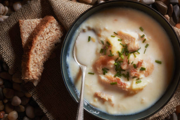 Cullen Skink soup with undyed smoked haddock. Scottish traditional soup known as Cullen Skink containing undyed smoked haddock, potatoes and milk. Named after the Aberdeenshire village of Cullen on the north coast of Scotland. Chowder stock pictures, royalty-free photos & images