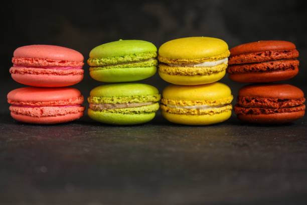 istock macaron or macaroon cake, colorful cookies (dark background). copy space 1090571752