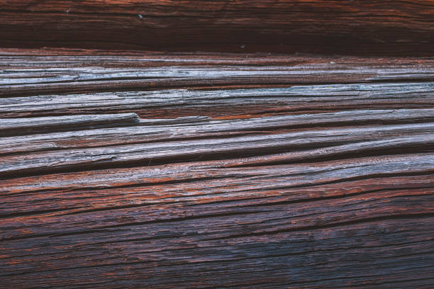istock Dark wooden dry red weathered logs cabin wall background 1090572666